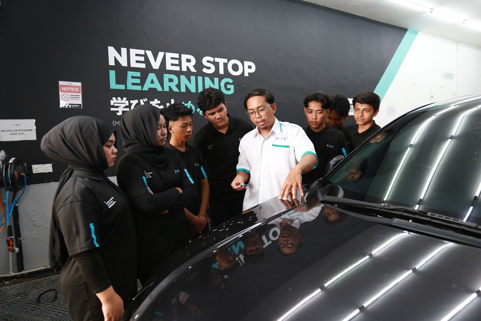 P10X Academy instructor checking bonnet surface with trainees