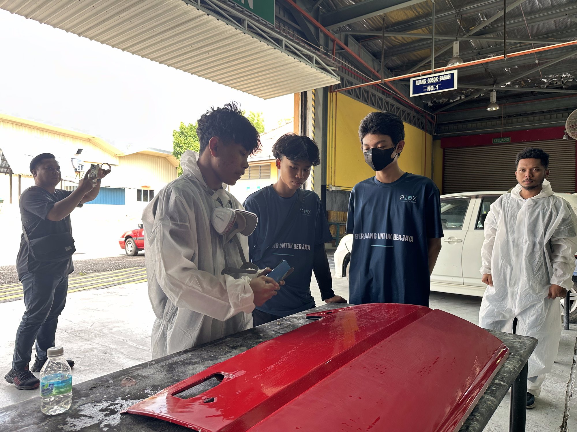 Outdoor spray paint workshop session with P10X Academy students