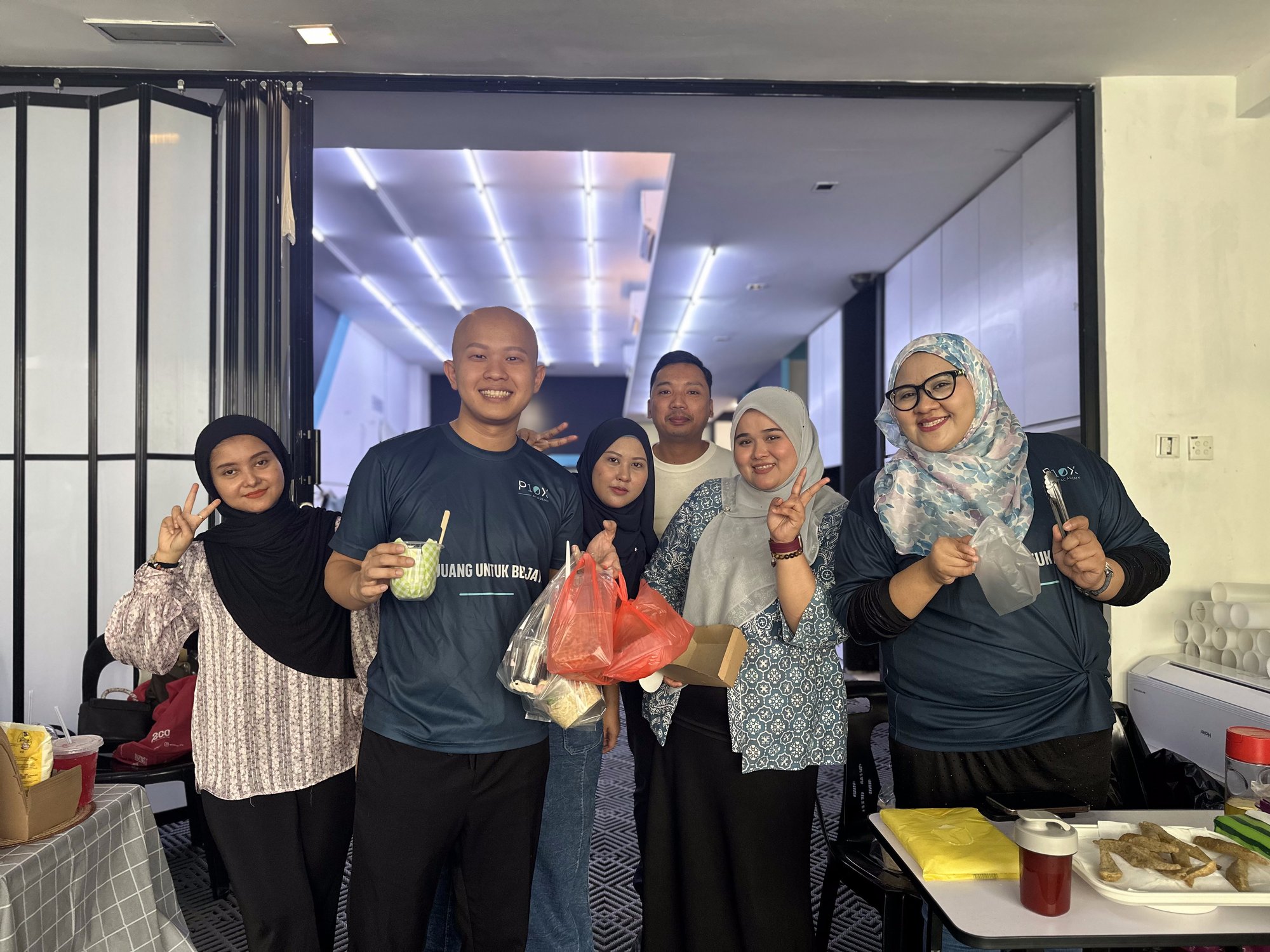 Students and staff gathering over refreshments