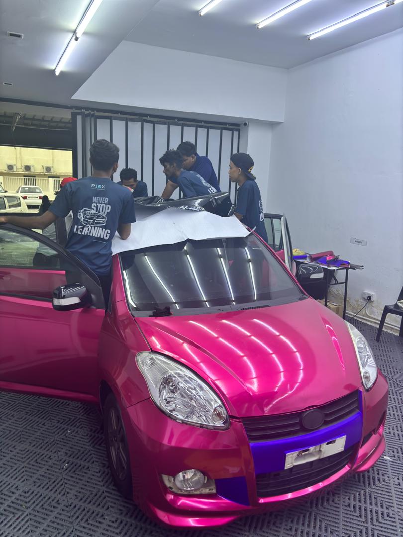 Kumpulan pelajar P10X Academy bekerjasama pada projek wrap cermin depan kereta