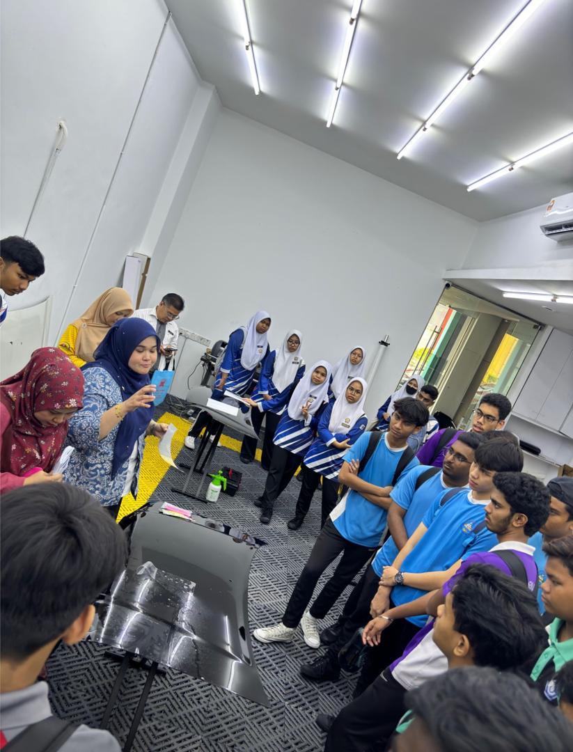 P10X Academy representative showing window film sample to school students at TVET Awareness Tour 2024